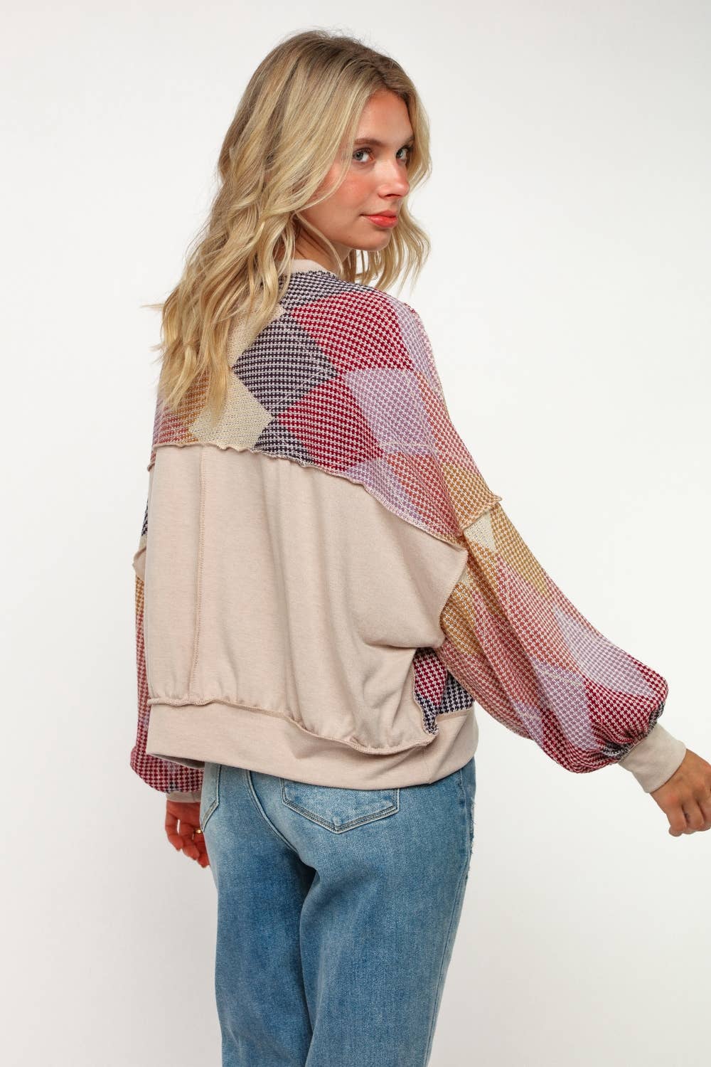 Back of lightweight women’s sweater with ribbed hem and cuffs in bold geometric diamond pattern.
