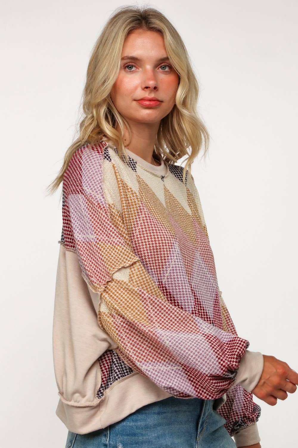 Women’s multicolor diamond-pattern sweater, relaxed fit crewneck with long sleeves, styled for casual fall fashion.