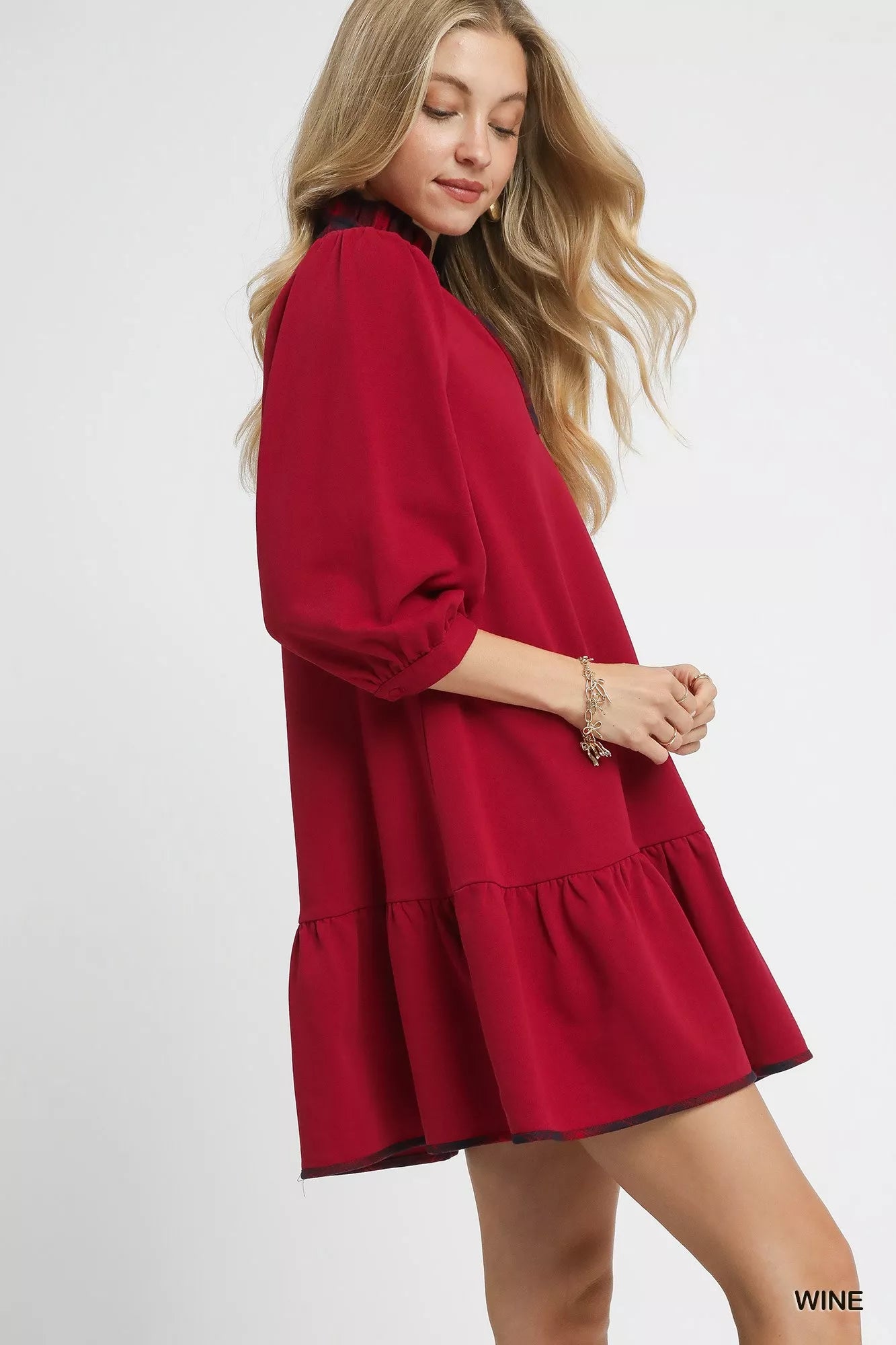 Crimson mini dress with ¾ sleeves and ruffled hem.