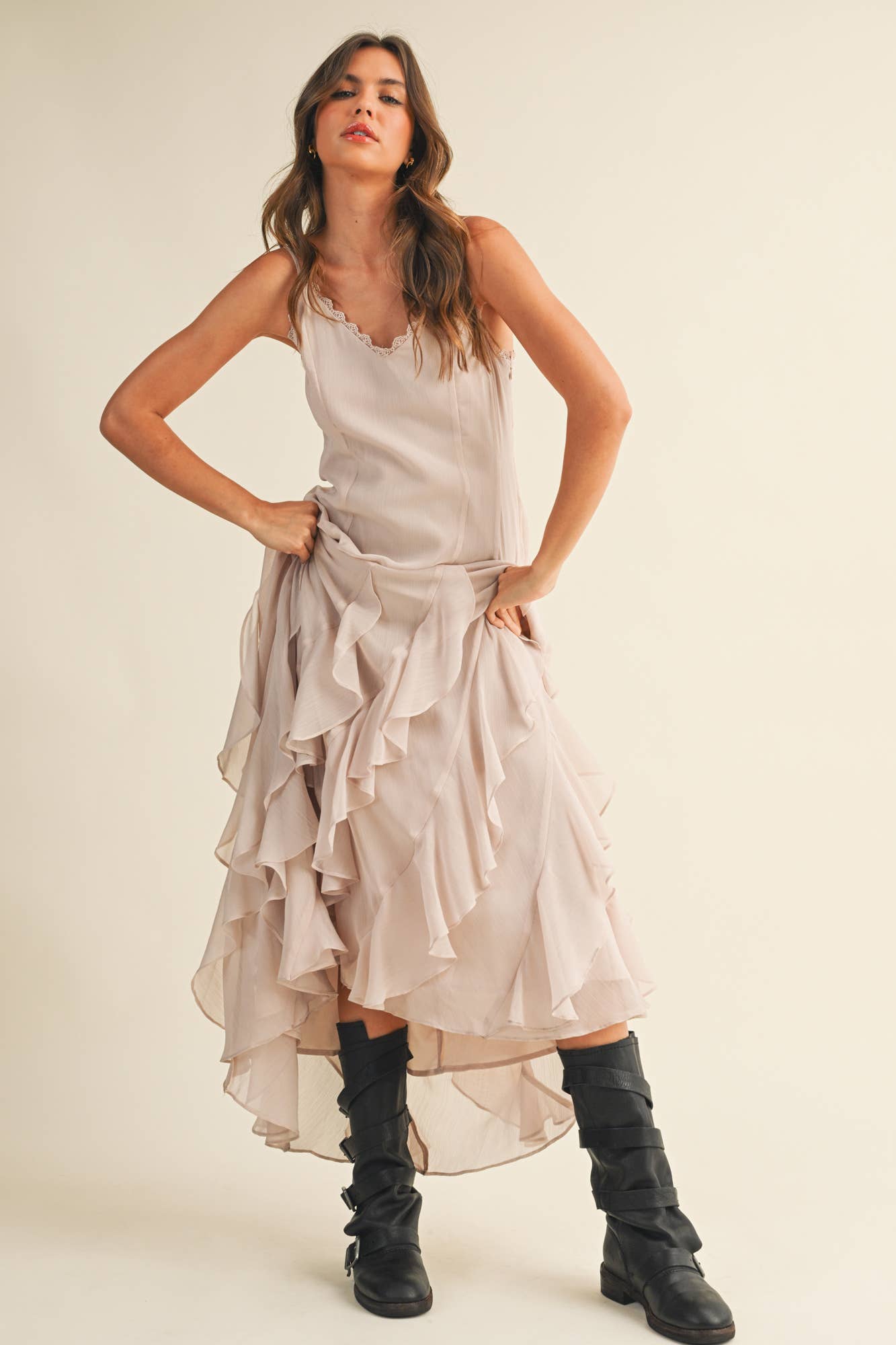 Elegant neutral ruffle dress styled with boots.