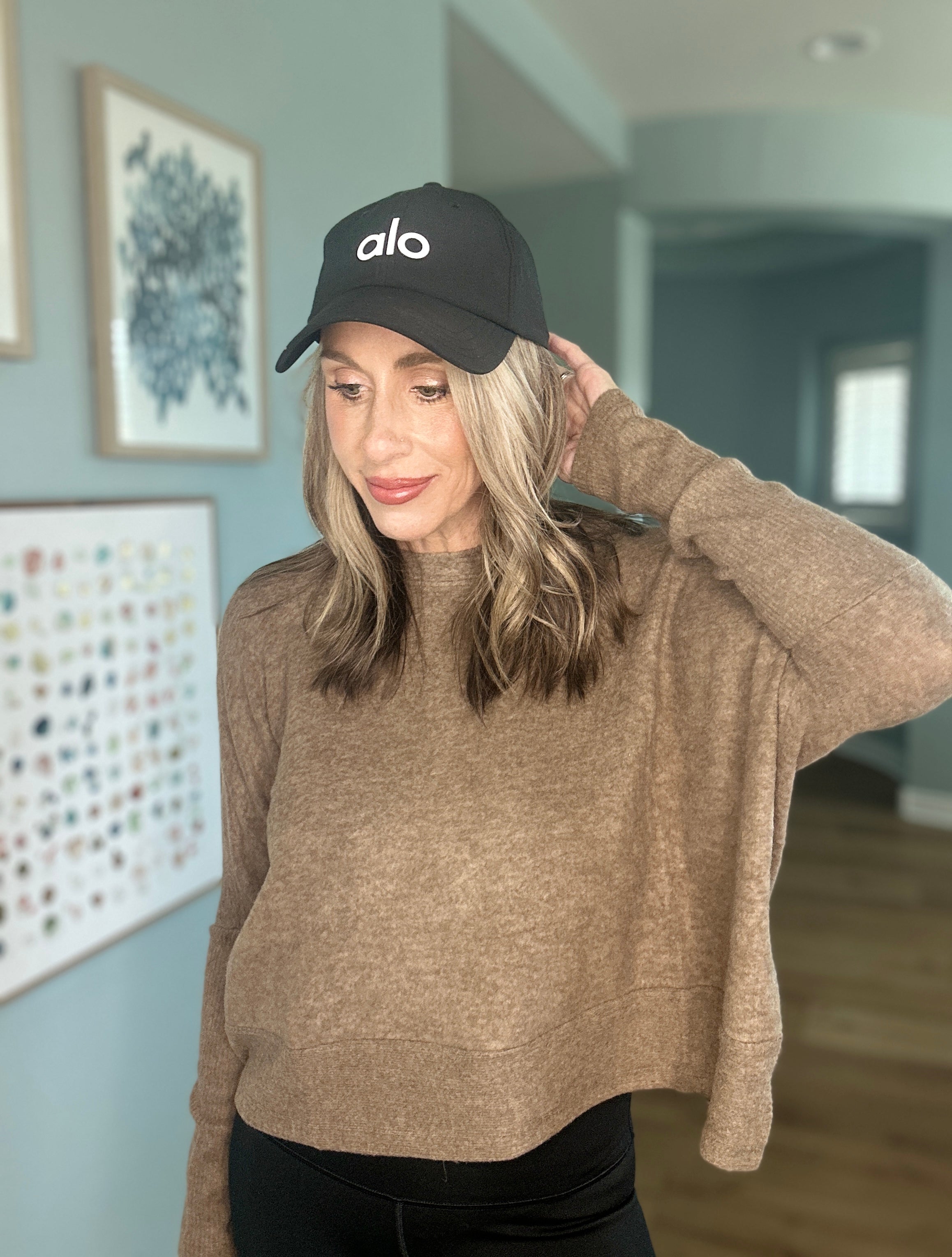 Soft mocha knit pullover with dropped shoulders and cozy oversized silhouette.