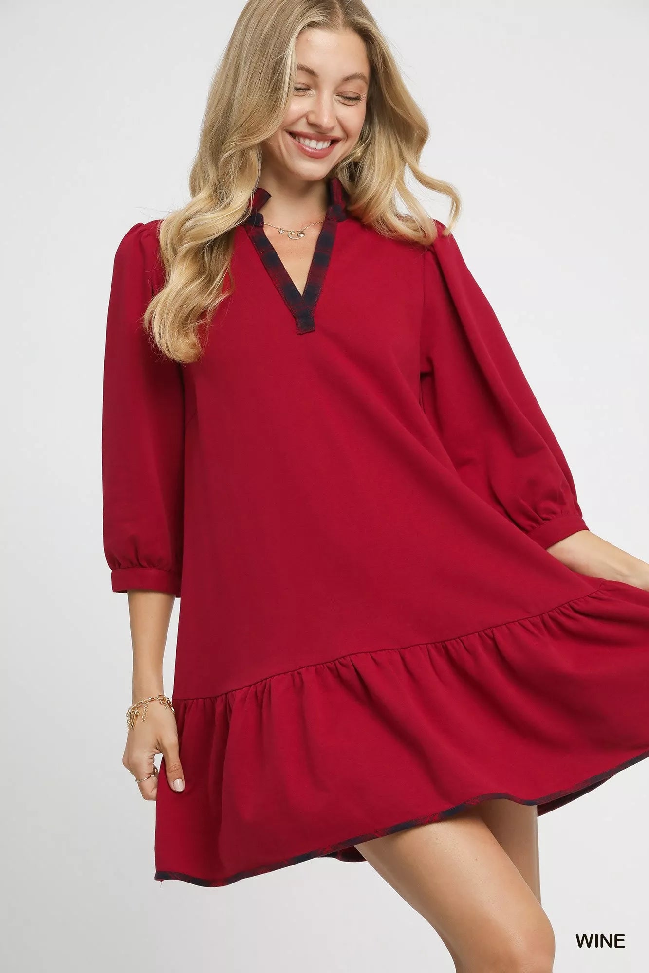 Red ruffle hem dress with plaid trim neckline.