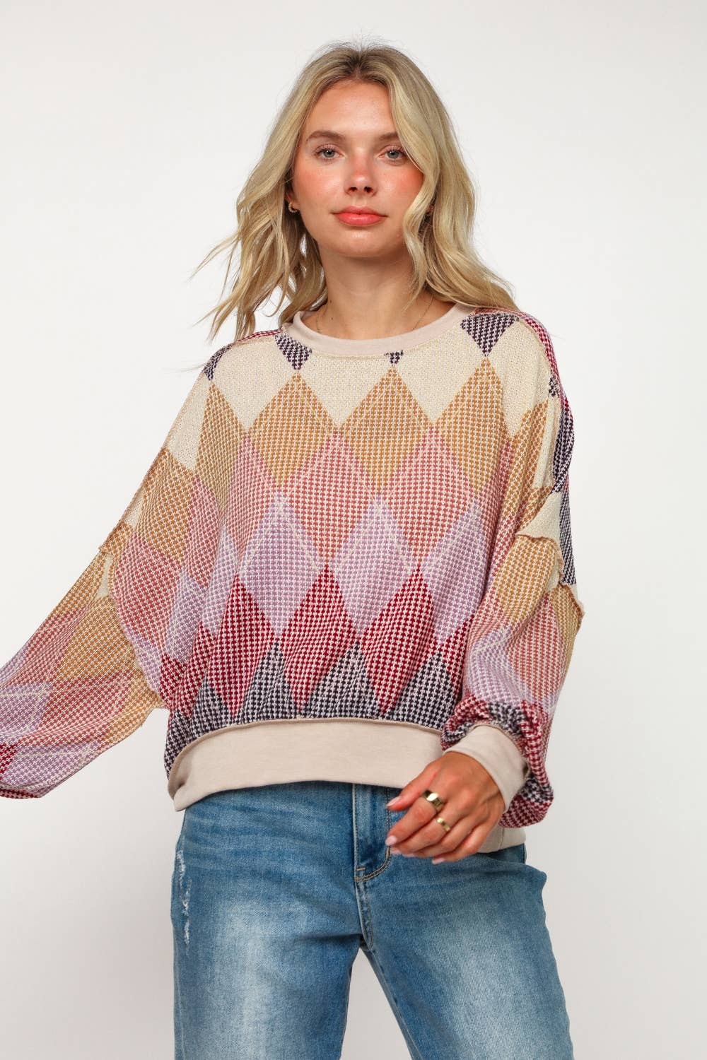 Women’s diamond knit sweater paired with jeans, cozy fall outfit for casual chic style.