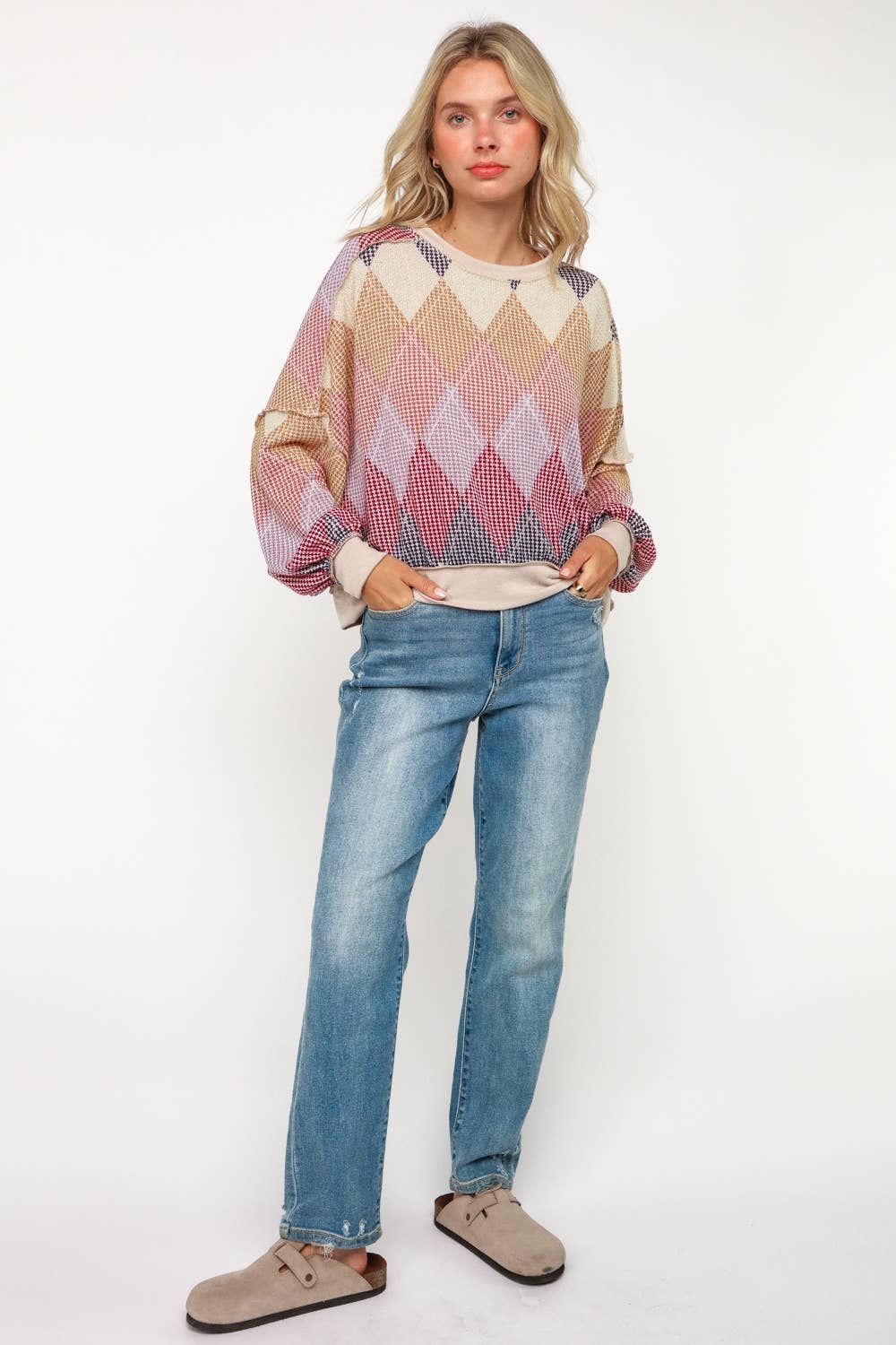 Women’s diamond knit sweater paired with jeans, cozy fall outfit for casual chic style.